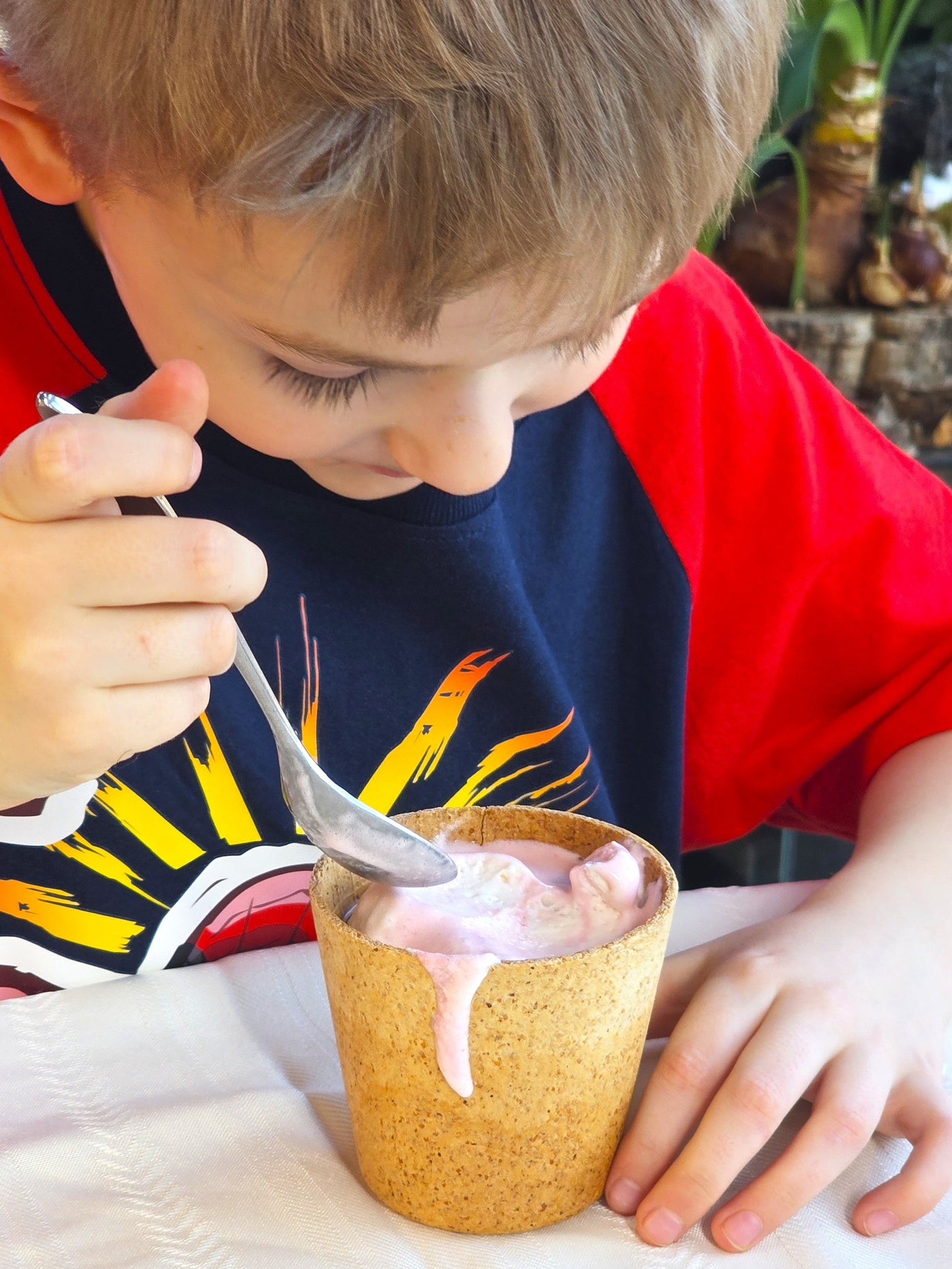 Person holding an edible coffee cup